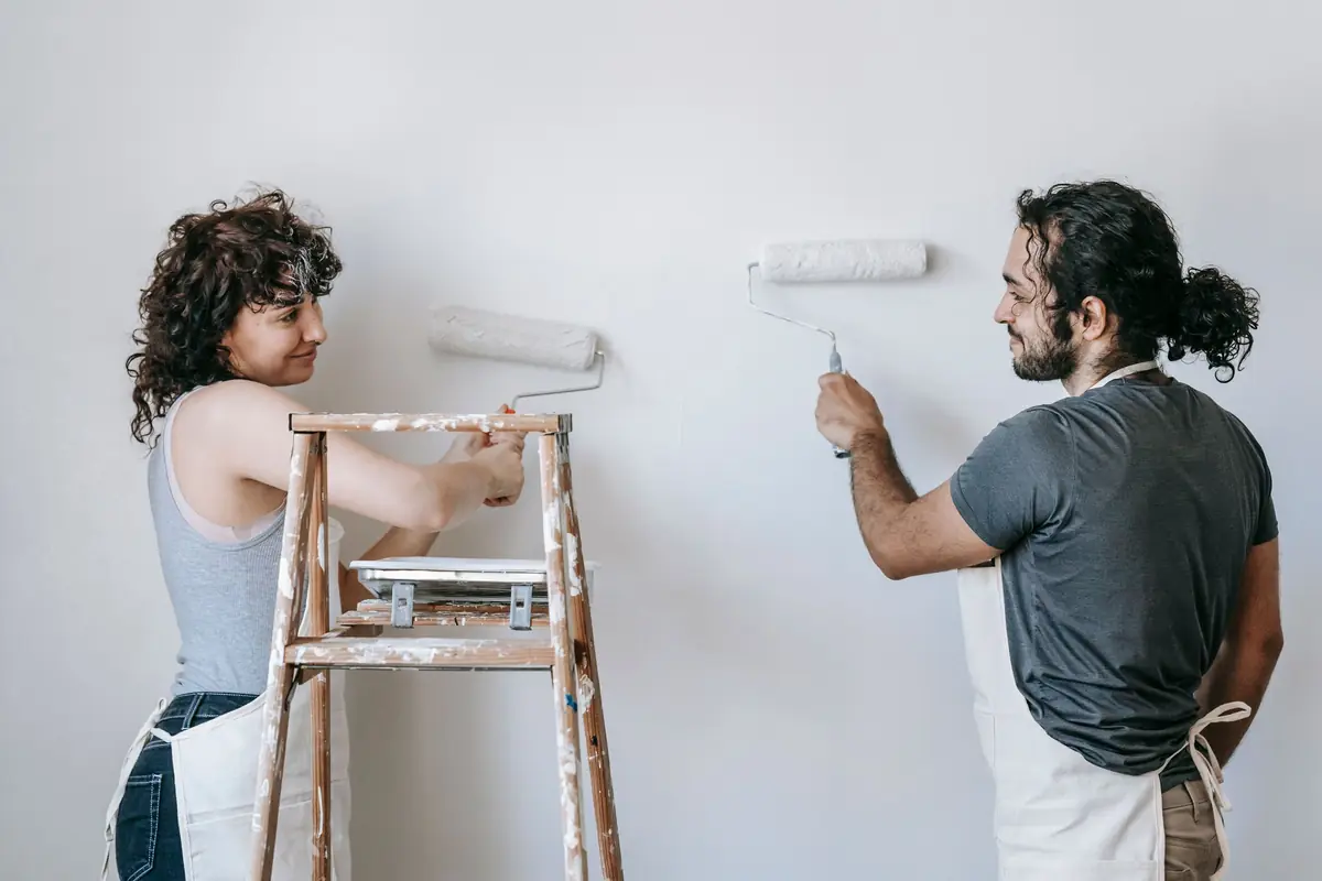 People painting a wall together — painting help in Anchorage